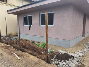 Applying Adhesive and Spackle to a House with a Metal Structure on the Ground Floor thumbnail