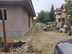 Applying Adhesive and Spackle to a House with a Metal Structure on the Ground Floor thumbnail