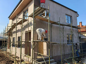 Applying Spackle in 2 Layers to the Facades of a Metal House thumbnail