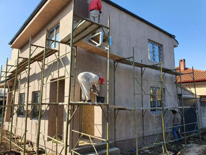 Applying Spackle in 2 Layers to the Facades of a Metal House thumbnail