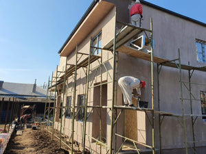 Applying Spackle in 2 Layers to the Facades of a Metal House thumbnail