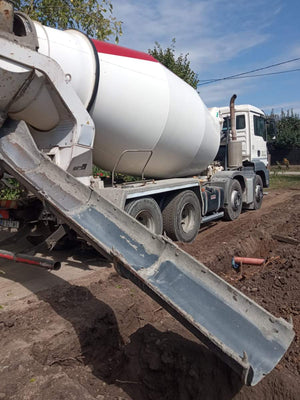Construction of a House on a Metal Structure Pouring Concrete Mortar into Foundation Trenches thumbnail