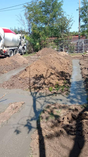 Construction of a House on a Metal Structure Pouring Concrete Mortar into Foundation Trenches thumbnail