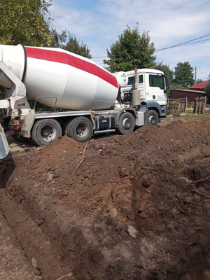 Construction of a House on a Metal Structure Pouring Concrete Mortar into Foundation Trenches thumbnail