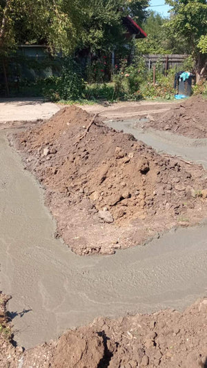 Construction of a House on a Metal Structure Pouring Concrete Mortar into Foundation Trenches thumbnail