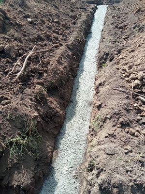 Construction of a House on a Metal Structure Pouring Concrete Mortar into Foundation Trenches thumbnail