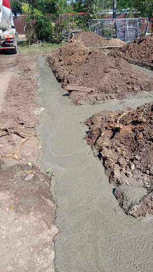 Construction of a House on a Metal Structure Pouring Concrete Mortar into Foundation Trenches thumbnail