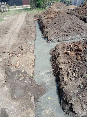 Construction of a House on a Metal Structure Pouring Concrete Mortar into Foundation Trenches thumbnail