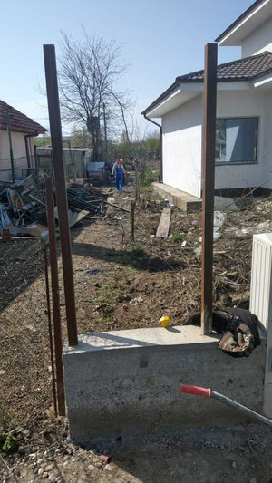 Construction of a Concrete and Wood Fence for a Metal House thumbnail