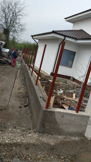 Construction of a Concrete and Wood Fence for a Metal House thumbnail