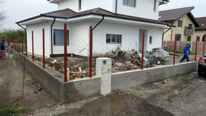 Construction of a Concrete and Wood Fence for a Metal House thumbnail