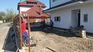 Construction of a Concrete and Wood Fence for a Metal House thumbnail