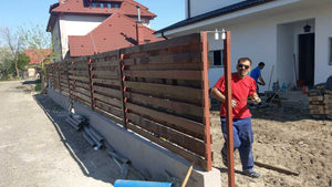Construction of a Concrete and Wood Fence for a Metal House thumbnail
