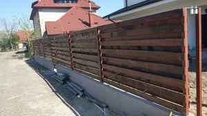 Construction of a Concrete and Wood Fence for a Metal House thumbnail