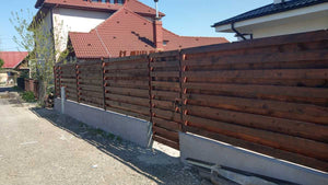 Construction of a Concrete and Wood Fence for a Metal House thumbnail