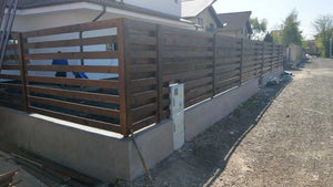 Construction of a Concrete and Wood Fence for a Metal House thumbnail