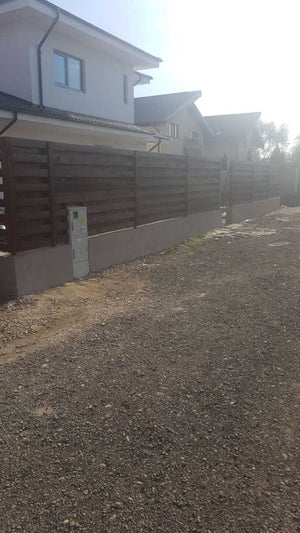 Construction of a Concrete and Wood Fence for a Metal House thumbnail
