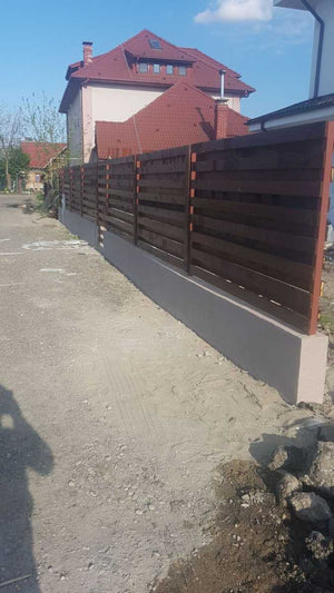 Construction of a Concrete and Wood Fence for a Metal House thumbnail