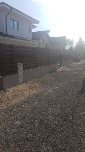 Construction of a Concrete and Wood Fence for a Metal House thumbnail