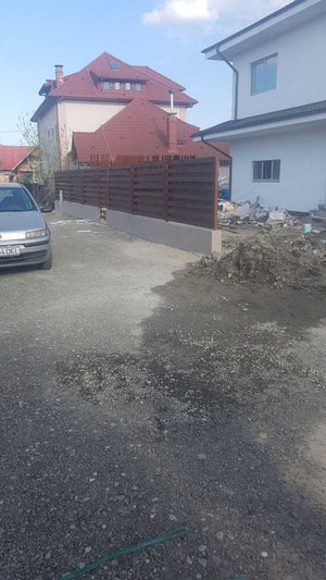 Construction of a Concrete and Wood Fence for a Metal House thumbnail