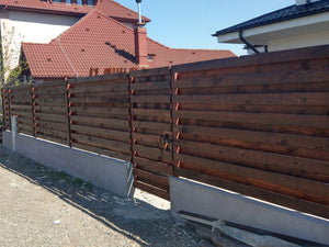 Construction of a Concrete and Wood Fence for a Metal House thumbnail