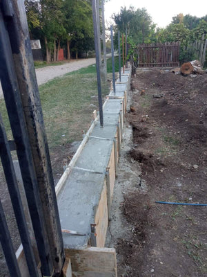 Construction of a Concrete Fence with Anthracite Gray Metal Strips, Gates, and Pedestrian Alley thumbnail