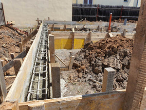 Construction of a Single-Story House Pouring Concrete into the Foundation Beams thumbnail