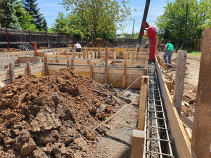 Construction of a Single-Story House Pouring Concrete into the Foundation Beams thumbnail