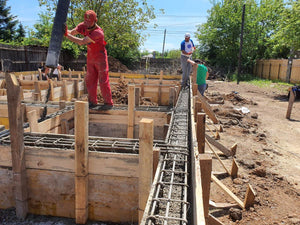 Construction of a Single-Story House Pouring Concrete into the Foundation Beams thumbnail