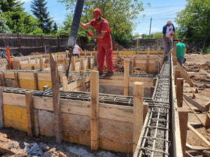 Construction of a Single-Story House Pouring Concrete into the Foundation Beams thumbnail