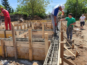 Construction of a Single-Story House Pouring Concrete into the Foundation Beams thumbnail
