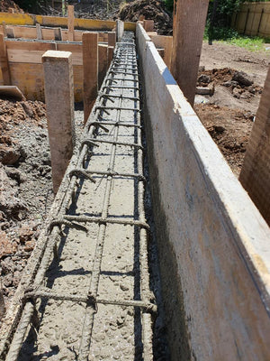 Construction of a Single-Story House Pouring Concrete into the Foundation Beams thumbnail