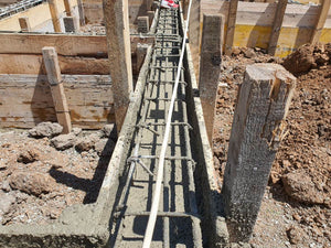 Construction of a Single-Story House Pouring Concrete into the Foundation Beams thumbnail