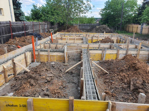 Construction of a Single-Story House Pouring Concrete into the Foundation Beams thumbnail