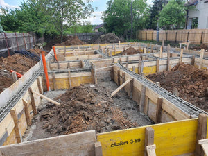 Construction of a Single-Story House Pouring Concrete into the Foundation Beams thumbnail