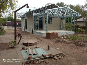 Exterior Cladding with Fiber Cement for a Single-Story Metal House with a Covered Terrace thumbnail