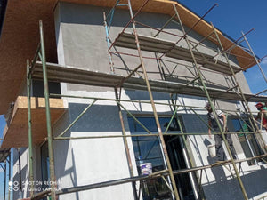 Primer Layer Applied to the Facades of a Metal House under Construction thumbnail