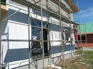 Primer Layer Applied to the Facades of a Metal House under Construction thumbnail