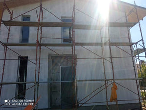 Primer Layer Applied to the Facades of a Metal House under Construction thumbnail