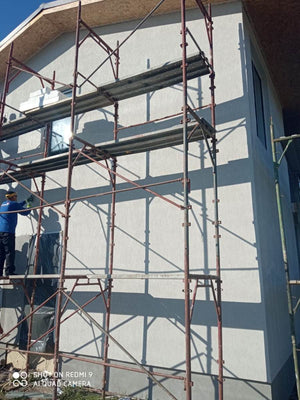 Primer Layer Applied to the Facades of a Metal House under Construction thumbnail