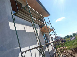 Primer Layer Applied to the Facades of a Metal House under Construction thumbnail